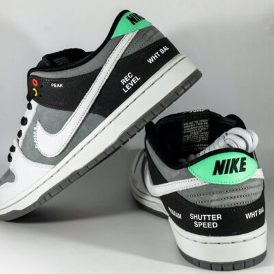 Close-up photo of Nike SB Dunk Low sneakers highlighting unique camcorder-inspired details.