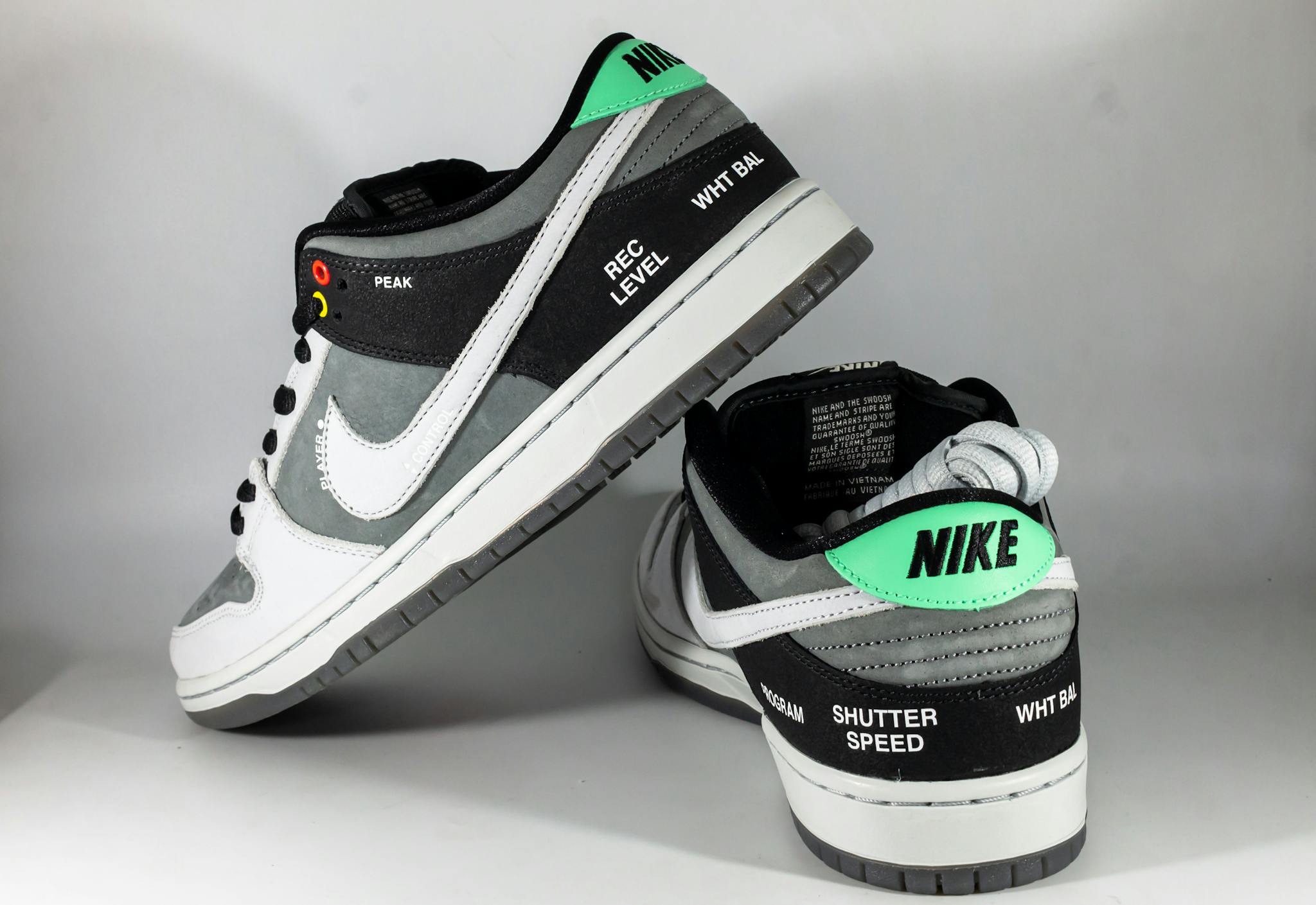Close-up photo of Nike SB Dunk Low sneakers highlighting unique camcorder-inspired details.